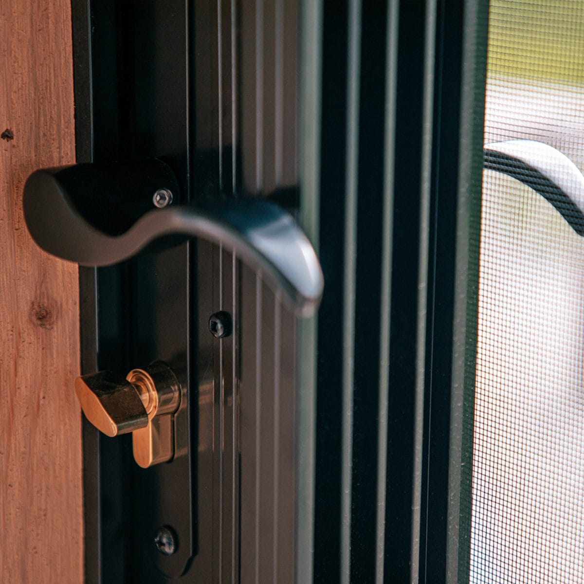 Close-up of Porch Conversions glass and vinyl wall system framing detail